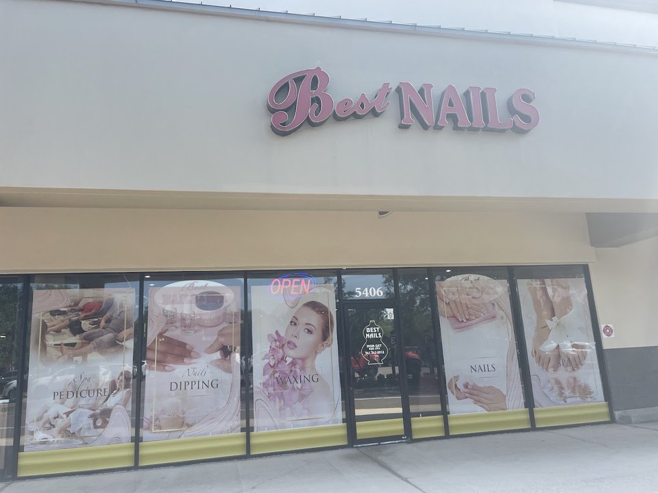Polished nails beside salon supplies